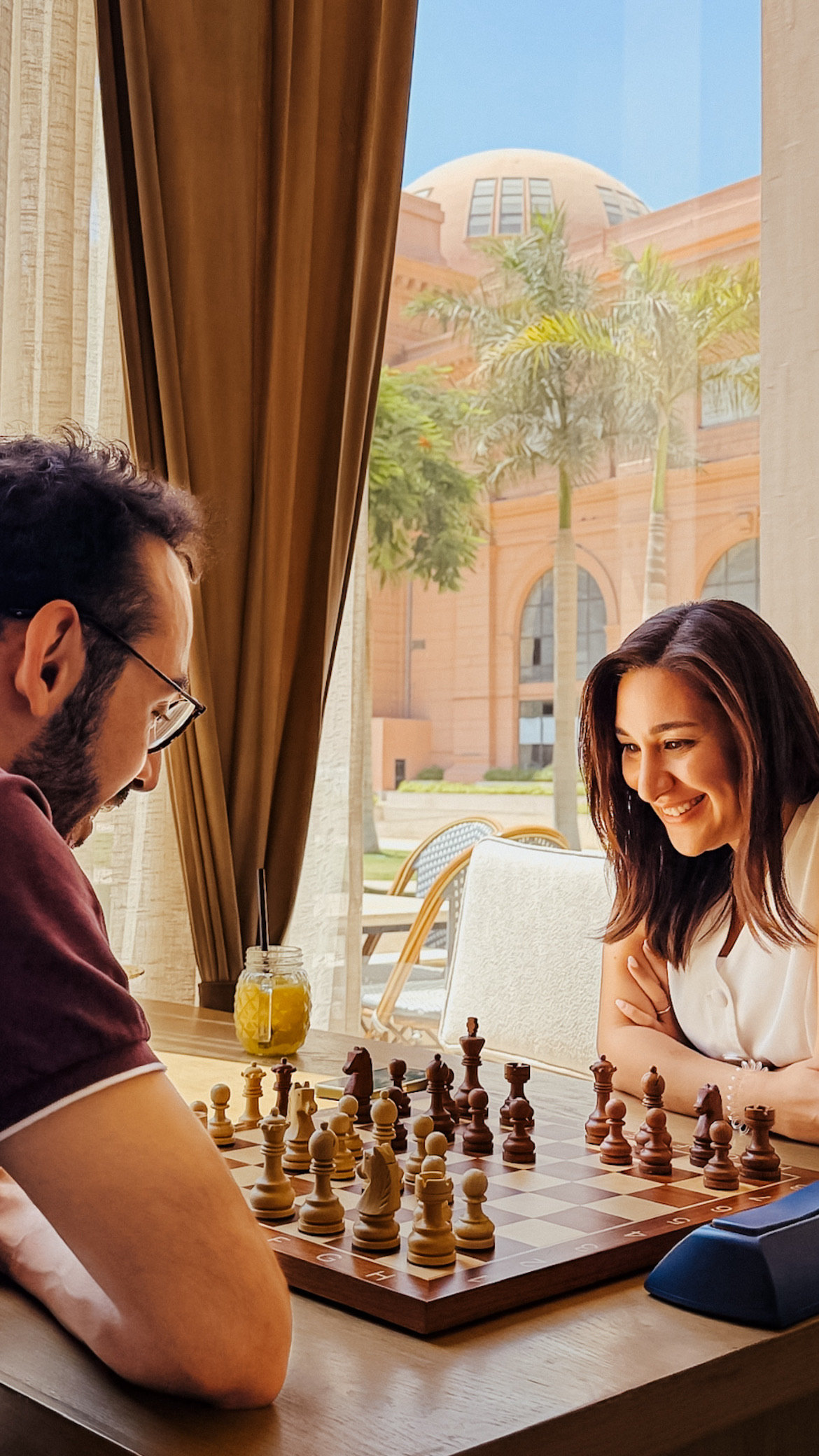 Two members laughing over a chess game