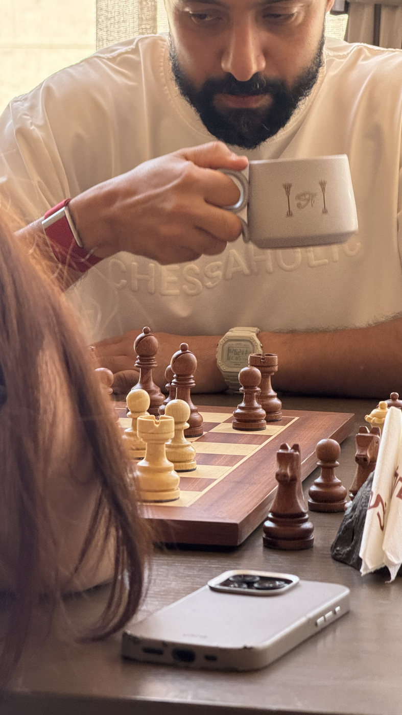 A cup of coffee beside a chess board